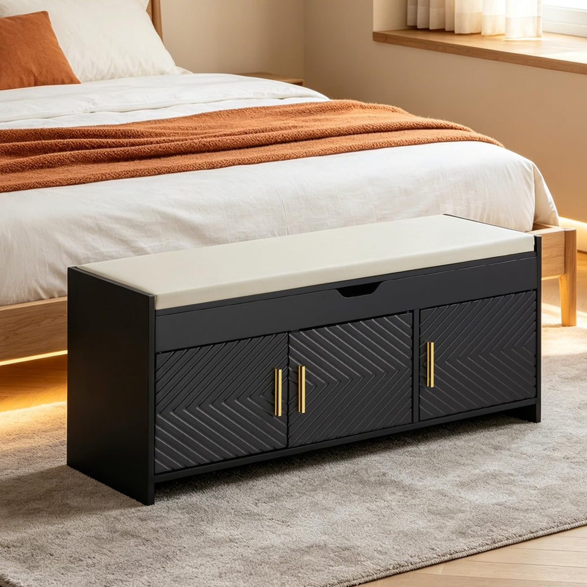 Black HOMREST shoe storage bench at the foot of a bed.